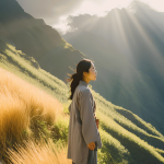 Person standing on a mountain, looking at sunrise, symbolizing hope and resilience after unmarried separation.